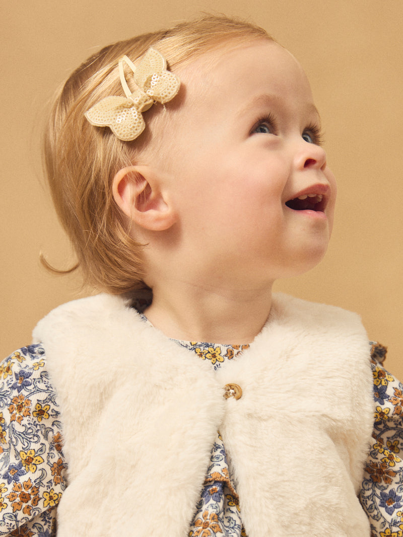 Gilet réversible blanc en fourrure ou imprimé fleuri Bébé Fille