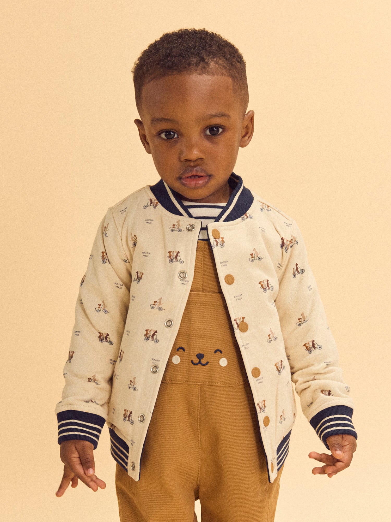 Teddy reversible azul marino o crema estampado de perros bebé niño